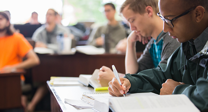 Students taking notes in a law class.