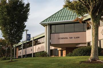 The facade of Roger Williams School of Law at sunset