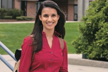 A student standing outside with a backpack on