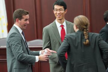 Business Law students talking in a courtroom.