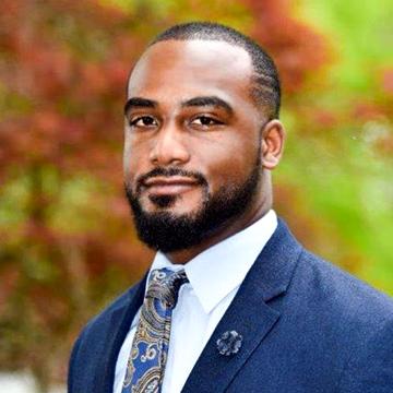 A headshot of Curtis