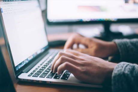 Person typing on laptop computer