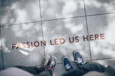 "Passion Led Us Here" on sidewalk