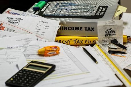 Income tax book, papers, and calculator