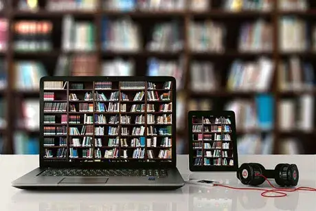Electronics with image of books on shelves on screens.