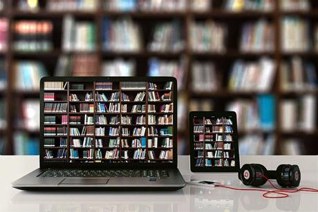 Computer and tablet with books and book shelves on screen