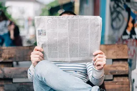 Person reading a newspaper 