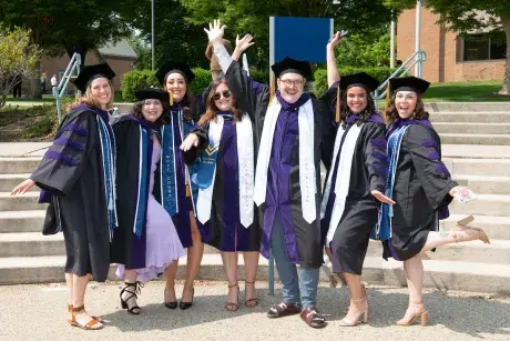 Graduates celebrate outside.