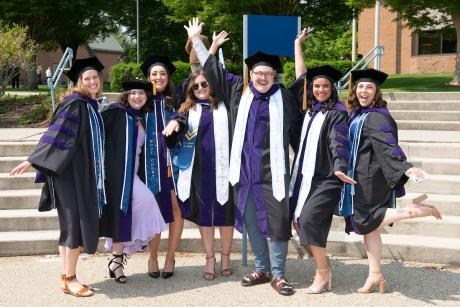 Graduates celebrate outside.