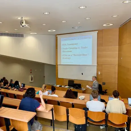Dean lecturing in a classroom with a few students