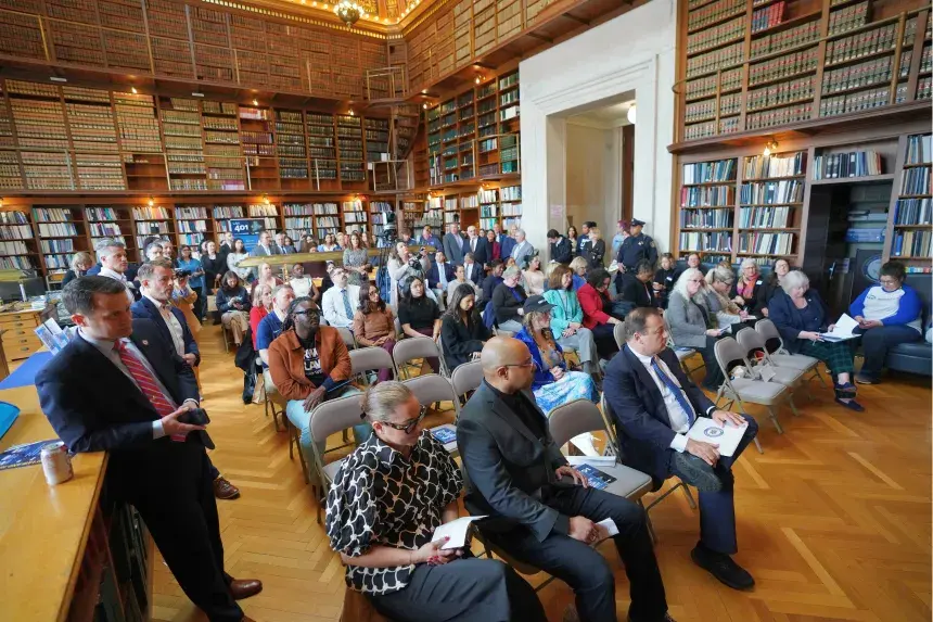 A large crowd gathers inside the Rhode Island State Library.