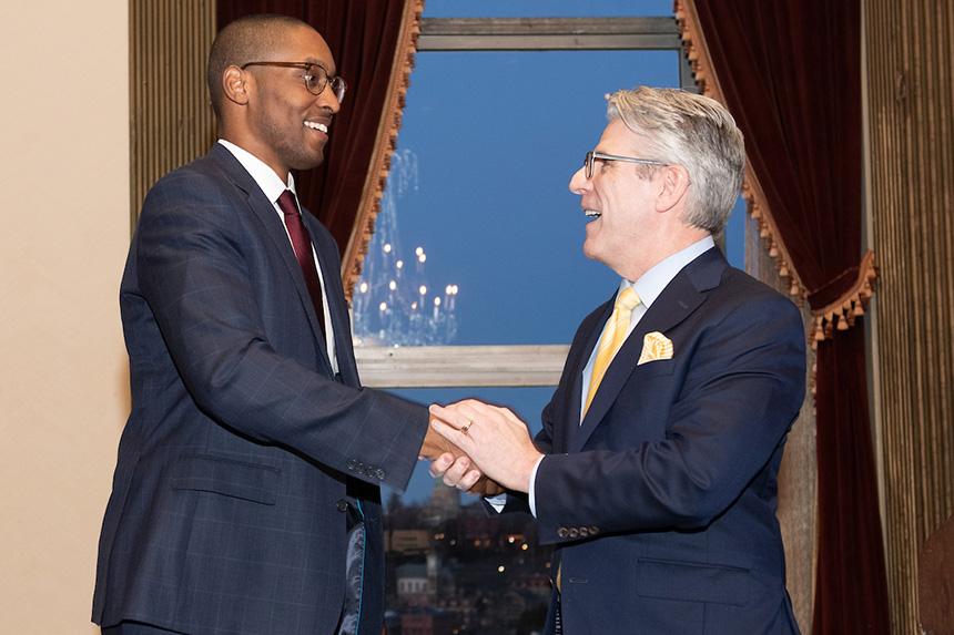 Dean Bowman shaking hands with someone at the Champions for Justice event